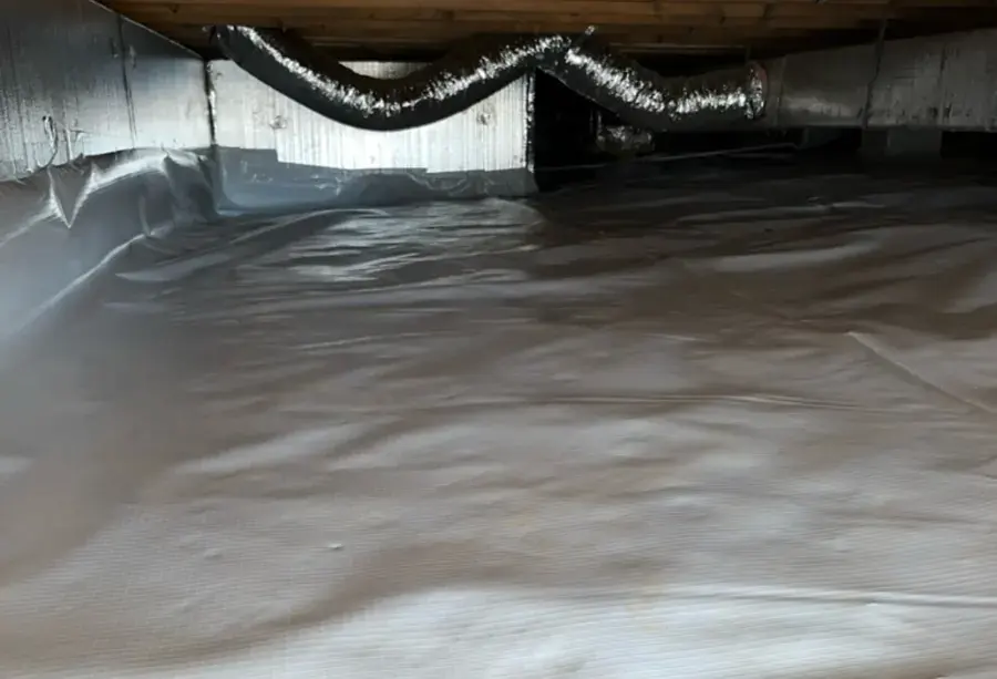 Crawl space with a white vapor barrier and flexible ducts under a raised floor, crawl space drying near Goose Creek