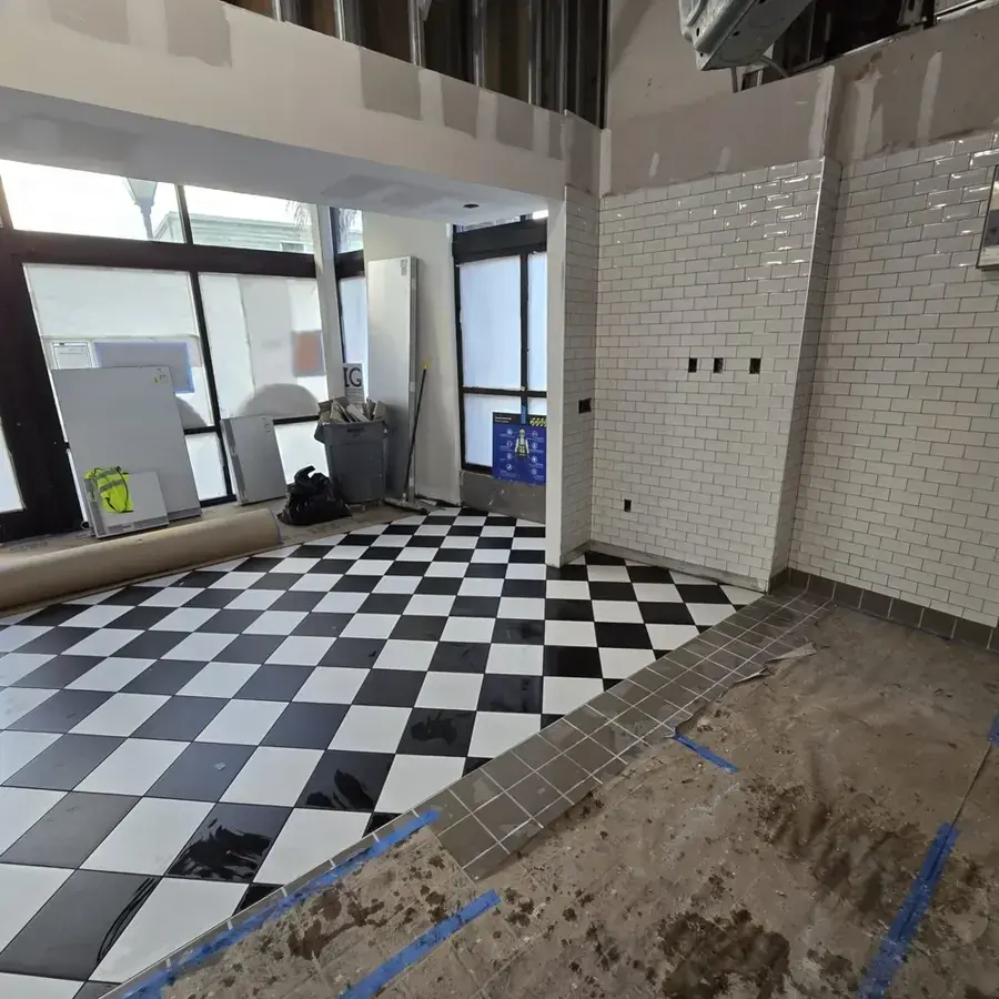Kitchen stripped to the studs with the floor drying after water damage in a Goose Creek home